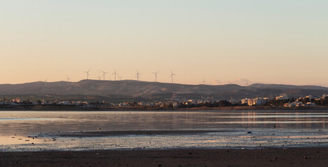 windmills at sunset over the lake