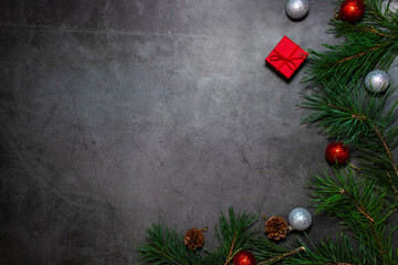 Christmas dark background. Flat Lay with Copy Space. Fir Branches with New Year's Toys on Dark Background.