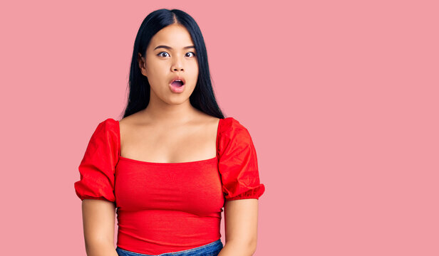 Young beautiful asian girl wearing casual clothes afraid and shocked with surprise expression, fear and excited face.