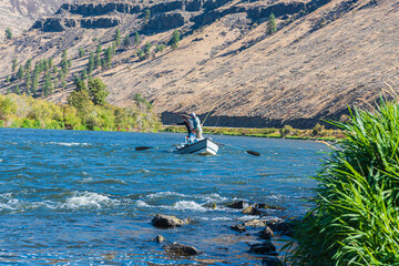 Landscape of Men Fly Fishing in a Drift Boat in the Yakima River Canyon © Robert Appleby