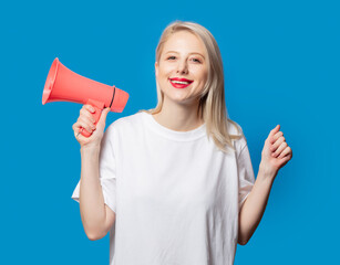 Blonde in white t-shirt with megaphone on blue background