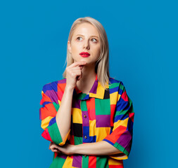 Blonde girl in 90s shirt on blue background