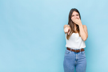 youn pretty woman laughing at you, pointing to camera and making fun of or mocking you