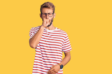 Handsome blond man with beard wearing casual clothes and glasses feeling unwell and coughing as...