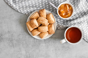 Tasty breakfast. Homemade sweet cinnamon cookies, cup of tea and apple confiture. Flatlay