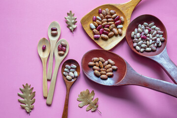 Beans in wooden spoons, geometric progression concept. Copy space