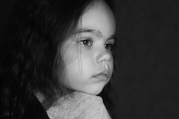 Black and white photo of a girl who looks into the distance