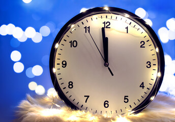 Fototapeta na wymiar The clock shows five seconds to midnight on a blurry background. New year's countdown