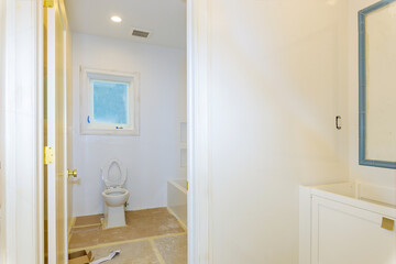 Fototapeta na wymiar Newly renovated bathroom toilet simple interior design white sanitary ware in the bathroom