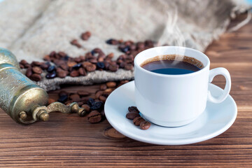 A cup of coffee with steam on the table. Planning and starting the day.