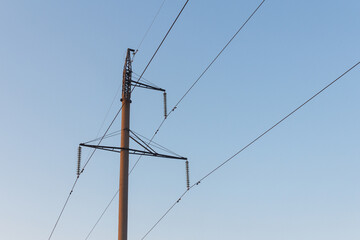 Closer look of the electric post with the big wires on it. Post with electric cables.