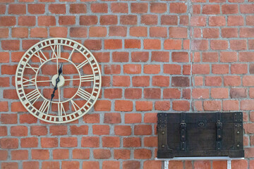 Clock and chest on brick wall background