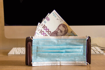 The wallet is on the table in the office.