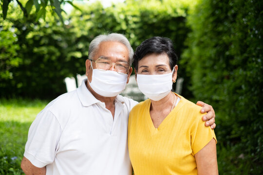 Senior Old Asian Couple, Wearing Face Mask To Protect Coronavirus Covid-19