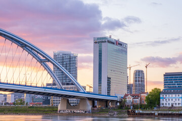 Fototapeta premium 2020: Long exposure Apollo bridge over river Danube in Bratislava, Slovakia. Sunset, golden hour, dramatic skies. High rise buildings, travel destination