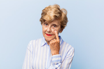 old pretty woman keeping an eye on you, not trusting, watching and staying alert and vigilant