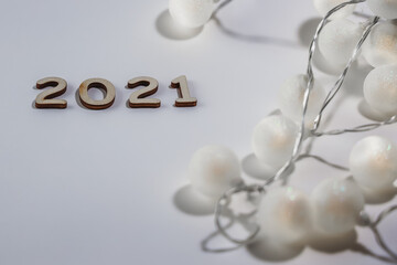 Merry Christmas and happy new year concept, wooden numbers 2021 on little shining balls background
