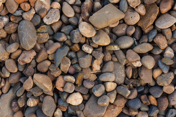 Colorful beach stone background. River pebble close-ups. View of pebbles from above