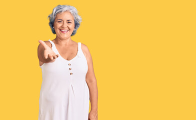 Senior woman with gray hair wearing casual clothes smiling friendly offering handshake as greeting and welcoming. successful business.