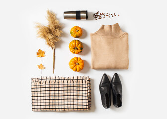 Fashion flat lay knolling with autumn and winter clothes - beige cozy sweater, plaid scarf, coffee...