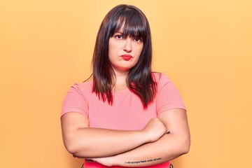 Young plus size woman wearing casual clothes skeptic and nervous, disapproving expression on face with crossed arms. negative person.