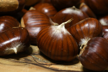 closeup of chestnuts on wood.