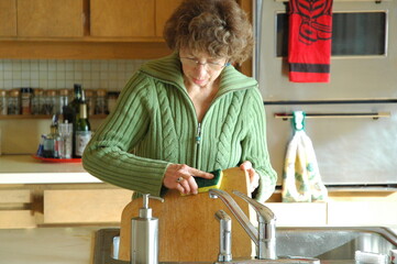 Female cleaning her kitchen at home.