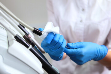 Disinfection of dental equipment. A dental assistant disinfects instruments before receiving...