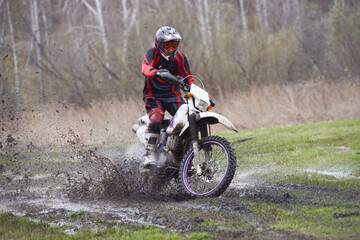 Fototapeta na wymiar Motorcross rider racing in mud track
