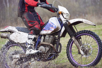 Motorcyclist racing in dirt