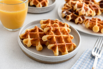 Belgian waffles with glass of orange juice for breakfast