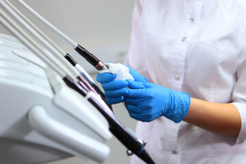 Disinfection of dental equipment. A dental assistant disinfects instruments on the mobile module....