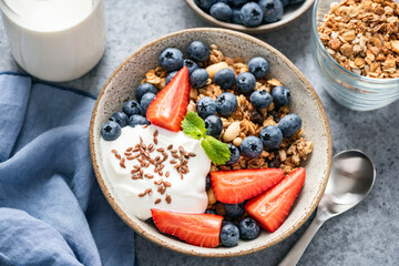 Granola bowl with yogurt and berries in a bowl. Healthy breakfast food