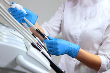 The dental assistant prepares the office for the reception of patients.Disinfection of dental instruments on the mobile module. The concept of sanitation and hygiene in the clinic.
