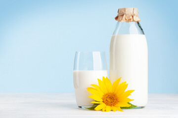 Milk in glass bottle and cup