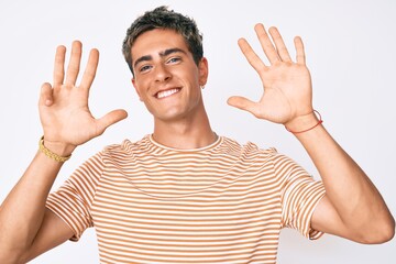 Young handsome man wearing casual clothes showing and pointing up with fingers number nine while smiling confident and happy.