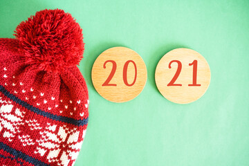 Happy new year 2021 concept with wool hat and number in green background. 2021 Creativity and inspiration ideas.