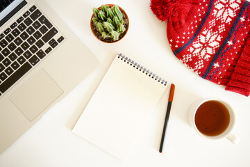 Christmas composition. Hot tea, empty notebook, laptop on white background. Christmas, winter, new year concept. Christmas accessories on the table