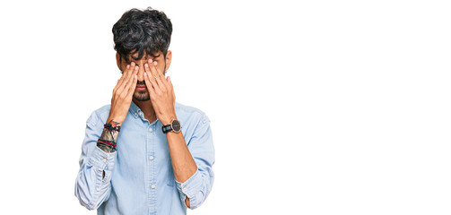 Young hispanic man wearing casual clothes rubbing eyes for fatigue and headache, sleepy and tired...