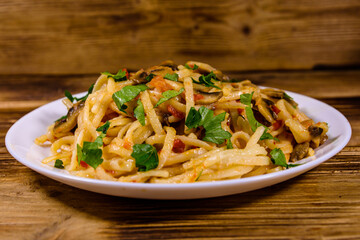 Pasta with mushrooms and tomato sauce in a plate