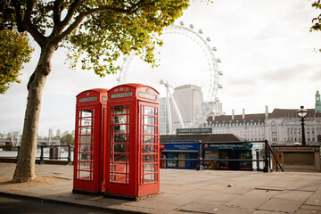 British Telephone Booths Under a Tree and with The London Eye as Background
