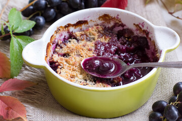 Crumble grape pie on wooden table