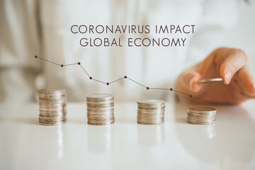 Coronavirus impact global economy. Finance, Business and Economy Concept. Descending cash money chart with hand. Effect of coronavirus in economy. Hand putting coins stacking with decreasing graph.
