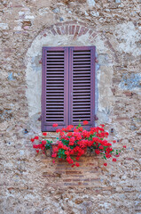 Fototapeta na wymiar Scenic window in the medieval town of San Gimignano, Italy