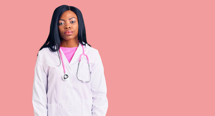 Young african american woman wearing doctor stethoscope looking sleepy and tired, exhausted for fatigue and hangover, lazy eyes in the morning.