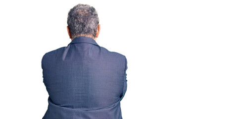 Senior grey-haired man wearing business jacket standing backwards looking away with crossed arms