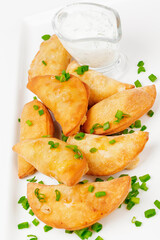 Fried stuffed dumplings with herbs on white