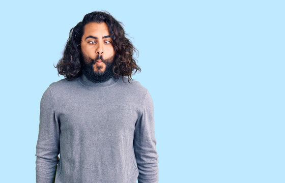 Young arab man wearing casual clothes making fish face with lips, crazy and comical gesture. funny expression.