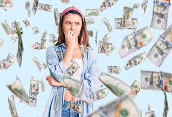 Young beautiful girl wearing casual shirt and diadem looking stressed and nervous with hands on mouth biting nails. anxiety problem.