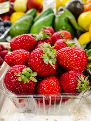Strawberries are on the counter in the supermarket